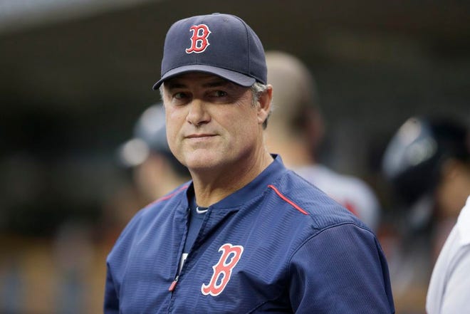 In this Saturday, Aug. 8, 2015 file photo, Boston Red Sox manager John Farrell is looks out from the dugout during the first inning of a baseball game against the Detroit Tigers in Detroit. The Red Sox say manager John Farrell's cancer is in remission, Thursday, Oct. 22, 2015.