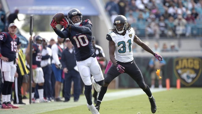 Houston Texans wide receiver DeAndre Hopkins (10) catches a long pass in front of Jacksonville Jaguars cornerback Davon House (31) during the second half an NFL football game in Jacksonville, Fla., Sunday, Oct. 18, 2015. The Texans won 31-20. (AP Photo/Phelan M. Ebenhack)
