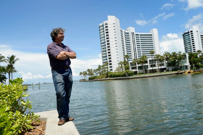 Achim Ginsberg-Klemmt stands atop a seawall where a nearby ditch empties into Sarasota Bay. Ginsberg-Klemmt and his wife say they own a section of property there, some submerged, that Sarasota city and county claim he does not own.