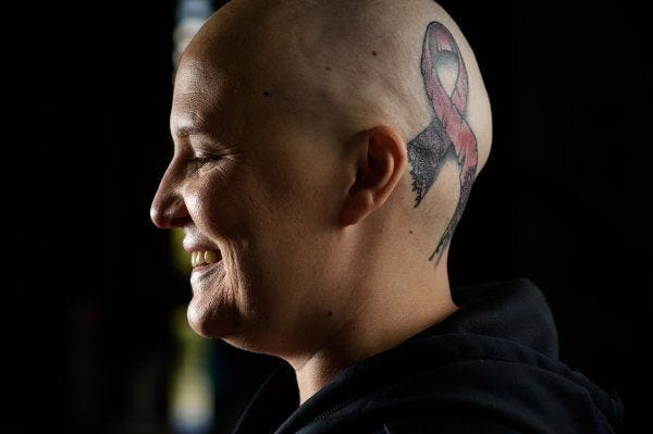 Bill Kirby Jr.: Tattered ribbon tattoo a symbol for woman fighting breast  cancer