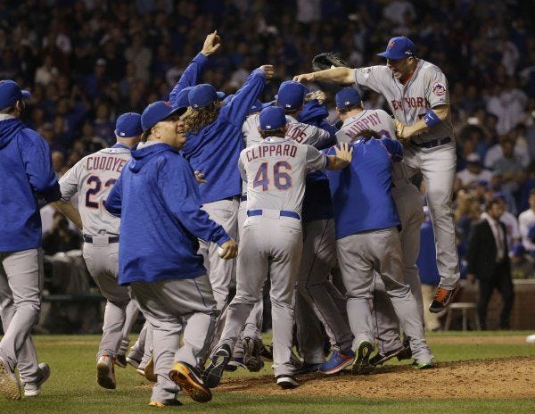 The New York Mets celebrate after Game 4 of the National League baseball championship series against the Chicago Cubs Wednesday, Oct. 21, 2015, in Chicago. The Mets won 8-3 to advance to the World Series. (AP Photo/David J. Phillip) David J. Phillip IL