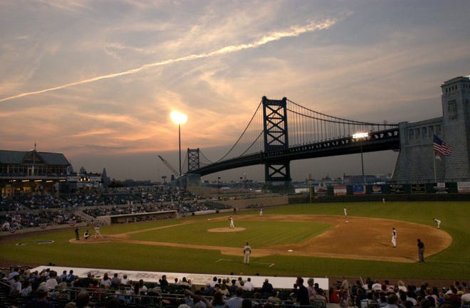 In this photo taken May 1, 2003, the sun sets as the Camden Riversharks play their home opener minor league baseball game against the Somerset Patriots at Campbell's Field in Camden, N.J. The Riversharks, who have spent 15 seasons playing in Camden, says it failed to reach a lease deal for its stadium and will cease operations. (Chris LaChall/Camden Courier-Post via AP)