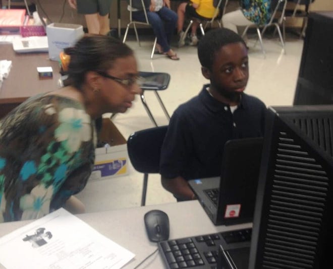 Pictured is seventh grader, Jeremiah Jackson and his mother, Lisa Jackson, as they navigate the school's BlackBoard page.
