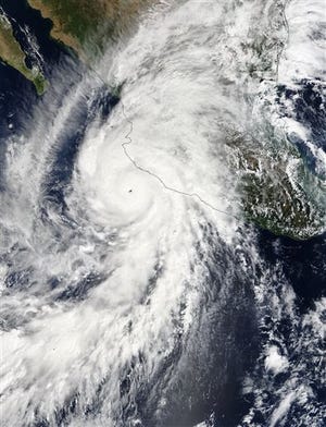 This satellite image taken at 1:30 p.m. EDT on Friday, Oct. 23, 2015, and released by NASA, shows the eastern quadrant and pinhole eye of Hurricane Patricia moving towards southwestern Mexico. The Category 5 storm is strongest ever in the Western Hemisphere, according to forecasters. (Goddard MODIS Rapid Response Team/NASA via AP)