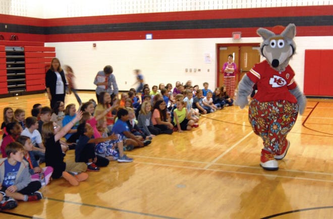 KC Wolf, mascot for the Kansas City Chiefs football team, struts while making an appearance Thursday at Lansing Elementary School. KC Wolf is portrayed by Dan Meers. Meers removed his costume and talked to students about making good choices. He visited several other schools Thursday in Leavenworth County. His appearances were sponsored by the Leavenworth County Sheriff's Office.