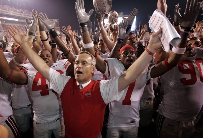 Coach Jim Tressel and the Buckeyes celebrate after a night-time victory at Texas on Sept. 9, 2006.