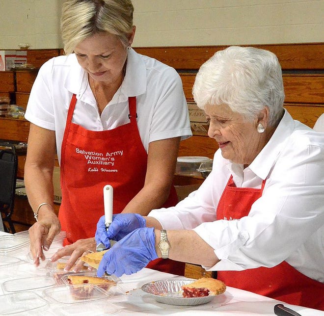 Kelli Weaver and Carole Brown slice and package pieces of pie for the Salvation Army’s 32nd annual Spaghetti Day Thursday.