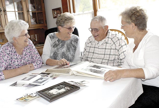 The Snook siblings of Centreville, Judy Gross, Marlene Marshall, Berton Snook and Lila Lutz, browse through wedding photos and reflect on a unique milestone: all four have been married 50 years or more after Marshall and her husband, Gale, marked their golden anniversary in August.