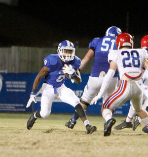 Tuscaloosa County’s Malik Smith (9) runs the ball for a gain.