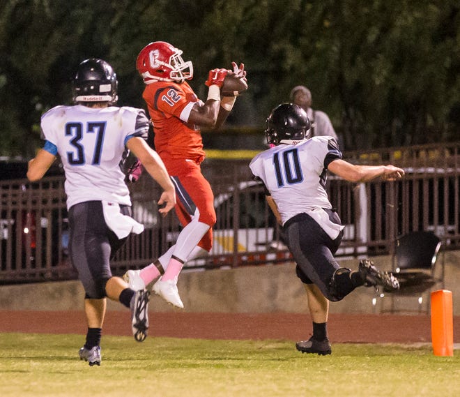 Central’s Carlos Taylor (12) catches a touchdown pass during Friday night’s game at Central. Taylor’s catch with 59 seconds left to play made it a two-point game. The two-point attempt, however, failed.