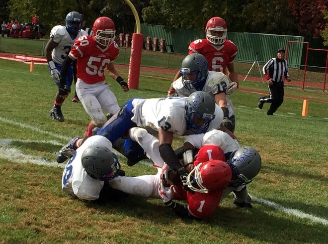 Northern Burlington's Torian Hopson (13), Anthony King (30), Connor Daniels (12) and M'Kiyah Folston-Anderson combine to stop Shemar Williams of Lawrence a yard short of the goal line during Saturday's WJFL Patriot Division game. Williams scored on the following play, but Northern won, 49-21.