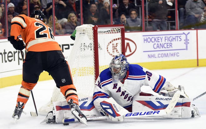 New York Rangers' Henrik Lundqvist blocks a shot from Philadelphia Flyers' Claude Giroux in overtime of an NHL hockey game, Saturday, Oct. 24, 2015, in Philadelphia. The Flyers won 3-2. (AP Photo/Michael Perez)