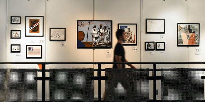 Paintings at the University of Southern California exhibit "Windows on Death Row: Art From Inside and Outside the Prison Walls" are seen as the exhibition prepares for its opening at the USC Annenberg School for Communication and Journalism in Los Angeles Thursday. The Associated Press