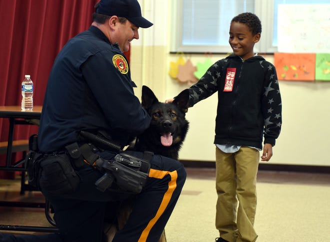 (File) A student at Hawthorne Park Elementary School in Willingboro meets police K-9 Ricky and his handler Patrolman John Michener as the team taught the kids about the dog's duties on Friday, Oct. 23, 2015. The Willingboro K-9 unit is one of about a dozen in Burlington County.