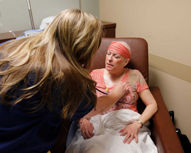 Cara Bragg R.N. BSN checks Fralick's breathing during an infusion treatment. Stage 4 breast cancer patient Celeste Fralick was undergoing a procedure in the Infusion clinic Wednesday, Oct. 7, 2015, in the Grace Clinic in Lubbock, Texas. (Mark Rogers/AJ Media)