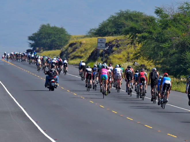 Athletes compete during the cycling portion of the Ironman World Championship Triathlon, Saturday, Oct. 10, 2015, in Kailua-Kona, Hawaii.
