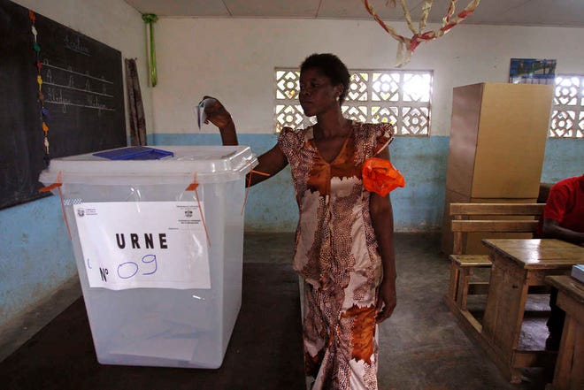A woman casts her ballot during elections in Abidjan, Ivory Coast, Sunday Oct. 25, 2015. Ivory Coast's president Alassane Ouattara is widely expected to win a second term as the West African nation votes, five years after a disputed poll that spilled over into the worst violence the country has experienced since independence.(AP Photo/Sevi Herve Gbekide)