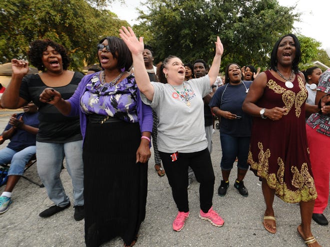 Charlene Davis, Debra Robinson, Angela Willett, Crystal Fordham and Tajuana Green sing "Every Praise is to My God" during Sunday evening's vigil for 11 year old Janiya Thomas, who's family discovered a body in a freezer that may be that of the missing girl. October 25, 2015;