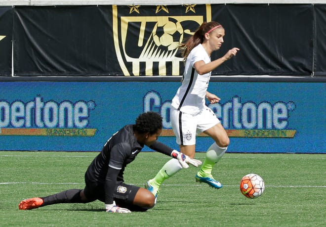 United States forward Alex Morgan, right, goes past Brazil goalkeeper Luciana, left, to score a goal in during the first half of an international friendly soccer match Sunday, Oct. 25, 2015, in Orlando, Fla.