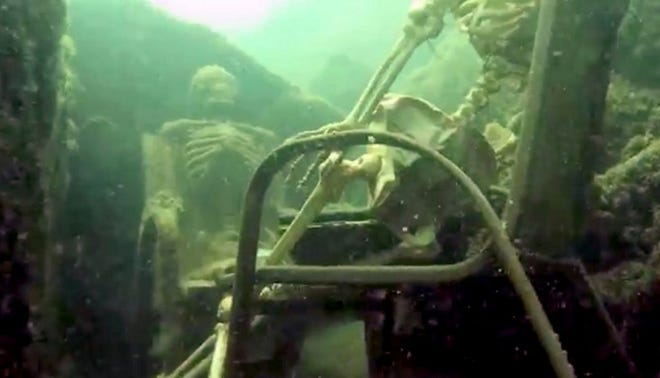 FILE - In this May, 2015 file image from video provided by the La Paz County, Ariz., Sheriff's Office, fake skeletons are strategically placed to appear as if they were sitting together with their lawn chairs bound to large rocks in the Colorado River near the Arizona and California border near Parker, Ariz. Martin Sholl, a diver who felt he didn't get his fair share of the credit for discovering the tableau, has removed them from their watery grave. Sholl says he spotted the skeletons, adorned in sunglasses, flip-flops, a bikini and a rainbow-colored wig, tethered to lawn chairs near Parker in May, 2015. Sholl says he pulled the pair from the river on Friday, Oct. 23, 2015 and put them on his balcony in Parker. (La Paz County Sheriff's Office via AP, File)