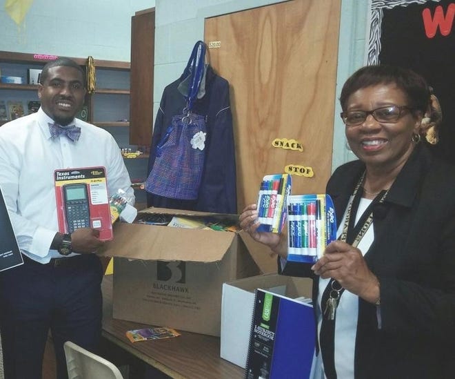 Sinclair Harris, Peabody Middle School assistant principal, left, and Cynthia Hawkes, school counselor, unpack an assortment of school supplies donated to the Petersburg school by Petersburg Lodge 237, Virginia Elks Association. Contributed Photo