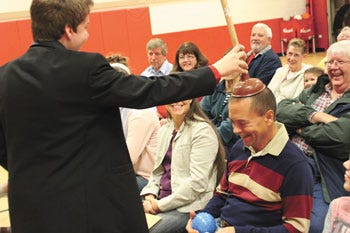 Magician Steven Elkowitz of Grand Rapids interacts with audience member Arthur Eichorn of Sturgis during Saturday's "Sharing the Magic" show to benefit the Colon Food Pantry.