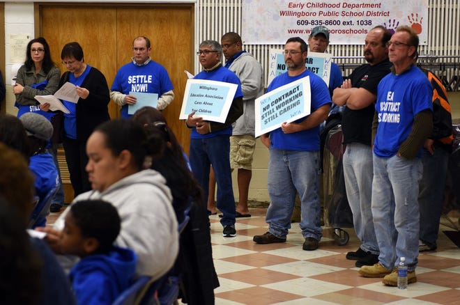 Members of the local teachers union call on the Willingboro school board to pursue a new contract at the board's meeting Monday, Oct. 26, 2015.
