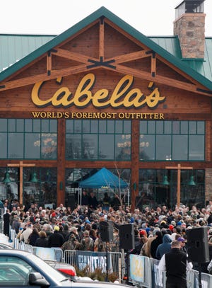 On March 7, 2013, opening day for the Columbus Cabela's store, customers and the curious waited to enter in a line that wound around the parking lot and stretched behind the store.