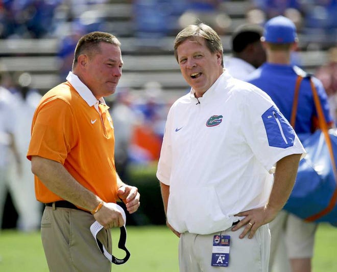 Tennessee head coach Butch Jones, left, and Florida head coach Jim McElwain chat at midfield before an NCAA college football game, Saturday, Sept. 26, 2015, in Gainesville, Fla. (AP Photo/John Raoux)