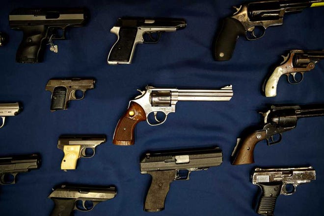 Guns seized by the police are displayed during a news conference in New York, Tuesday, Oct. 27, 2015. Officials announced charges Tuesday in a gun trafficking case where more than 70 firearms were seized. (AP Photo/Seth Wenig)