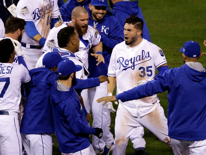 Kansas City Royals' Eric Hosmer is congratulated after hitting a sacrifice fly during the 14th inning of Game 1 of the Major League Baseball World Series against the New York Mets Wednesday, Oct. 28, 2015, in Kansas City, Mo. The Royals won 5-4 to take a 1-0 lead in the series.