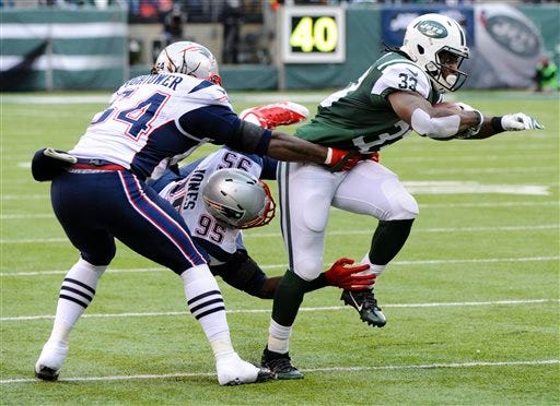Jets running back Chris Ivory breaks a tackle by Chandler Jones, middle, and Dont'a Hightower. The Associated Press