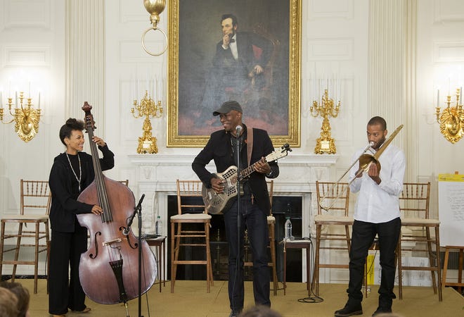 In this photo taken Oct. 14, 2015, jazz musician Esperanza Spalding, from left, Grammy award-winning blues musician Kebí Moí, and trombone and trumpet player from New Orleans, La., Trombone Shorty, perform during an interactive student workshop with middle school students from the Washington area, in the State Dining Room of the White House in Washington. Whether belting out lyrics to Al Greenís "Letís Stay Together," leading a mournful congregation through "Amazing Grace," or tweeting his Spotify music playlist that includes Stevie Wonder and Nina Simone, President Barack Obama is showing that heís a pretty soulful guy. (AP Photo/Manuel Balce Ceneta)