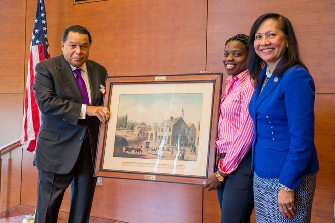 Alumnus William Hayden '62 presented a historic lithograph of downtown New Bedford to UMass Dartmouth on Oct. 21, 2015. COURTESY PHOTO/ UMASS DARTMOUTH
