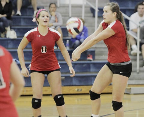 New Bern girls’ volleyball player Avery Davis (9) sets the ball against the Hoggard Vikings as Kjersti Solter (8) looks on in Wilmington in an intense back and forth battle at Hoggard. New Bern plays at Panther Creek at 6 p.m. on Thursday.