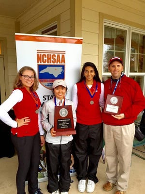From left, Terry Sanford golfers Carmen Tucker, Marisa Kawabe and Preeya Shah  pose with coach Doug Ginn and their runner-up trophy after Tuesday's state 3-A championship.