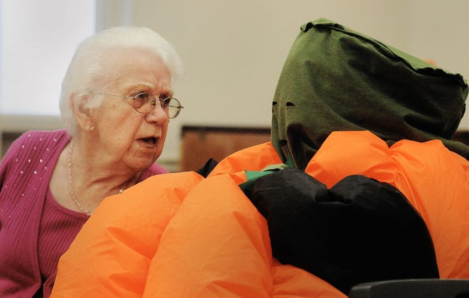 Modeena Fitch tries to figure out who the giant pumpkin is sitting next to her during a Halloween luncheon held at the Middletown Senior Citizen Center on Thursday, Oct. 29, 2015. The luncheon was sponsored by Woodbourne Place in Middletown.