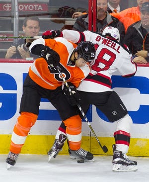 The Devils' Brian O'Neill (18) and the Flyers' Michael Del Zotto battle on the boards during the first period of a hockey game at the Wells Fargo Center on Thursday, Oct. 29, 2015 in Philadelphia. O'Neill is from Yardley and went to Germantown Academy. The Flyers lost to the Devils 4-1.