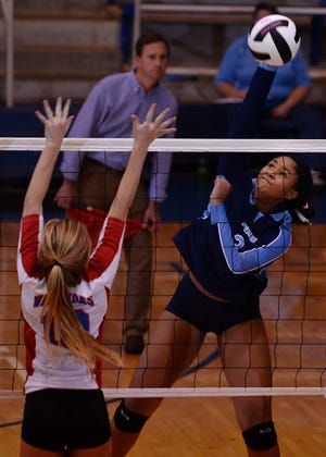 Dorman's Omara Daniels (3) puts the ball over the net against Riverside's Hallie Bowers (10) during Thursday night's first-round 4A state playoff match. TIM KIMZEY/tim.kimzey@shj.com