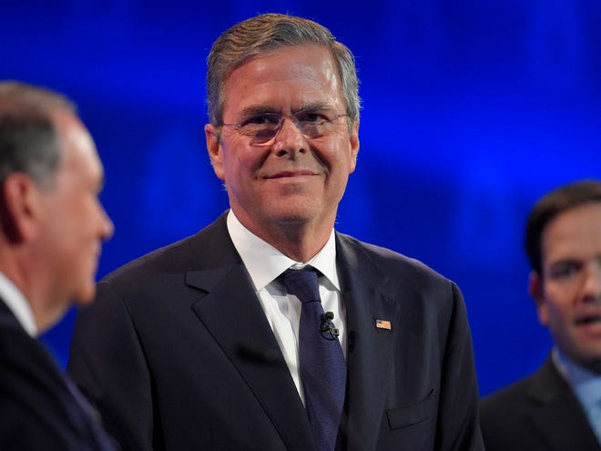Jeb Bush, center, stands with Mike Huckabee, left, and Marco Rubio during the CNBC Republican presidential debate at the University of Colorado, Wednesday, in Boulder, Colo.
