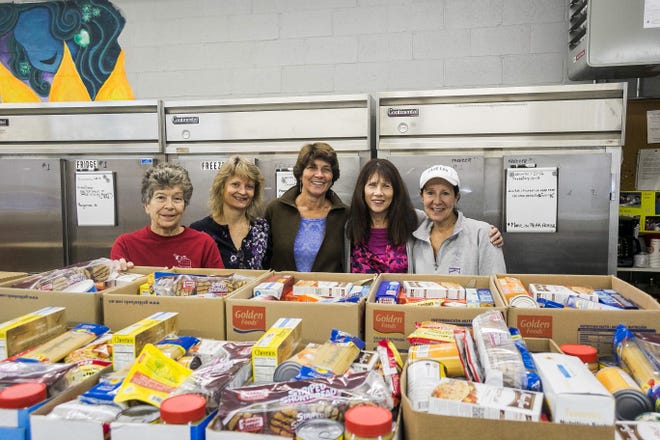From left to right, Rita LaBella, Patty Haversat, Jennifer Morley, Elizabeth Gillis and Paula Phenix, are among the many volunteers that keep the Tewksbury Food Pantry operating. The boxes contain non-perishable available to Tewksbury residents each month. Bruce Coulter/Wicked Local staff writer