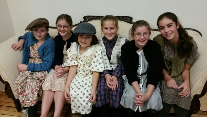 Annie Jr. cast members, from left, Riley Bettes from Lakeville, Arianna Ribeiro from Lakeville, Grace Lyerla from Middleboro, Allison Cowgill from Middleboro, Sara White from Middleboro and Isabella Corey from Duxbury, take a break during rehearsals. Annie Jr. opens December 3 and runs through December 12 at The Alley Theatre. Submitted