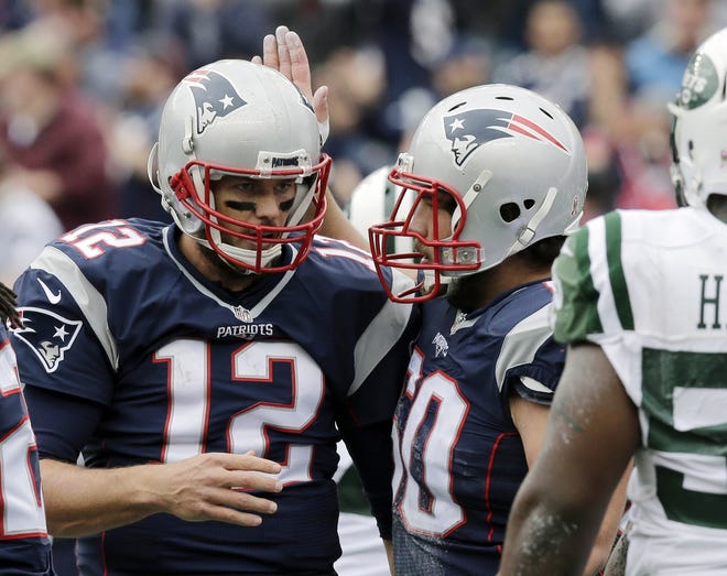 Patriots center David Andrews, right, congratulates quarterback Tom Brady after his touchdown run against the New York Jets last week. Andrews has started all seven games this year, but now Bryan Stork is healthy. AP FILE PHOTO
