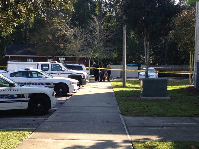 Police officers work at the scene of a shooting Friday morning at Tiger Bay apartments in Gainesville.