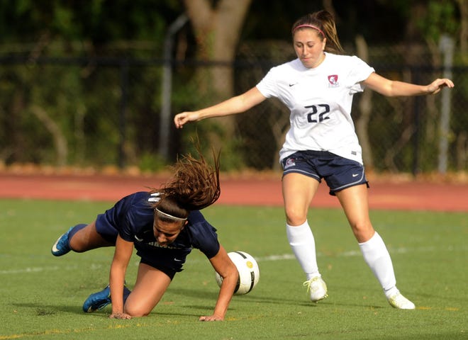 Christina Corbi of Shawnee is upended by Shanna Bryson (22) of Eastern while going for the ball in Saturday's South Jersey Coaches association Tournament championship game at Paul VI High School.