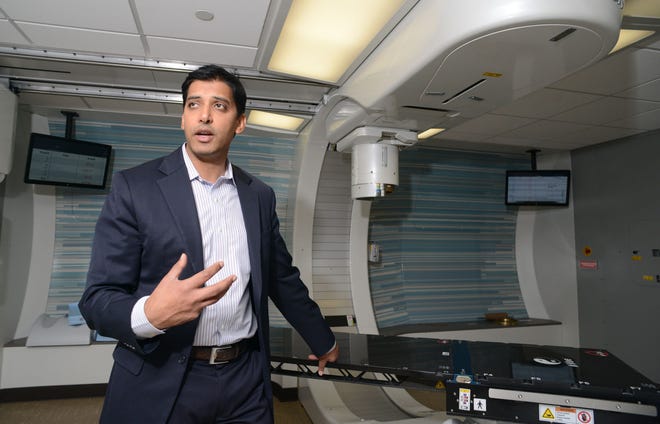 Dr. Atif Khan, radiation oncologist at Laurie Proton Therapy Center shows equipment used to treat cancer patients.