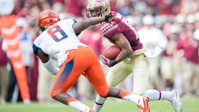 TALLAHASSEE, FL - OCTOBER 31: Wide receiver Travis Rudolph #15 of the Florida State Seminoles looks to maneuver by safety Antwan Cordy #8 of the Syracuse Orange on October 31, 2015 at Doak Campbell Stadium in Tallahassee, FL. (Photo by Michael Chang/Getty Images)