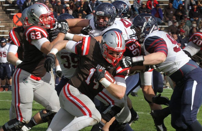 Brown's Seth Rosenbauer fights for yardage against the Penn defense during second-quarter action on Saturday.