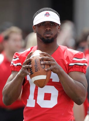 Ohio State quarterback J.T. Barrett is shown during Ohio State's Spring game in Columbus. Barrett has been suspended for one game after being cited with a misdemeanor offense of operating a vehicle under the influence.A statement from the school says Barrett was stopped at a Columbus police check point early Saturday morning.