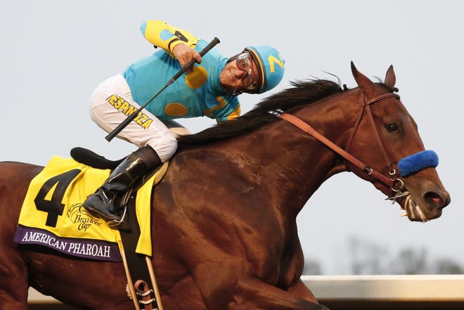American Pharoah, with Victor Espinoza up, wins the Breeders' Cup Classic horse race at Keeneland race track Saturday. The Associated Press